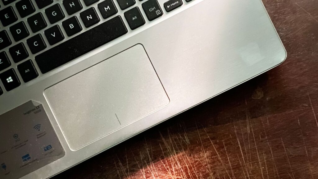 Close-up of an affordable budget laptop keyboard and trackpad on a desk