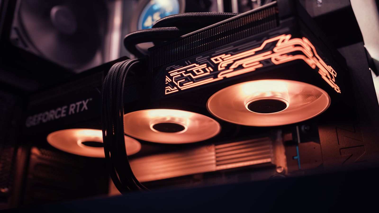 A high-end graphics card with lit fans installed in a PC case