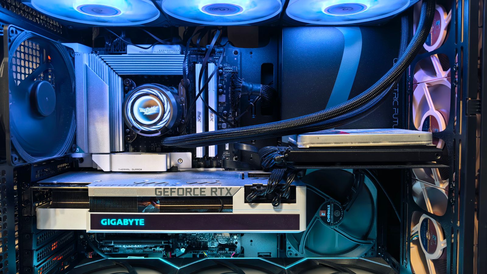 Inside a 2026 gaming PC build showing the motherboard, memory, graphics card and liquid cooler