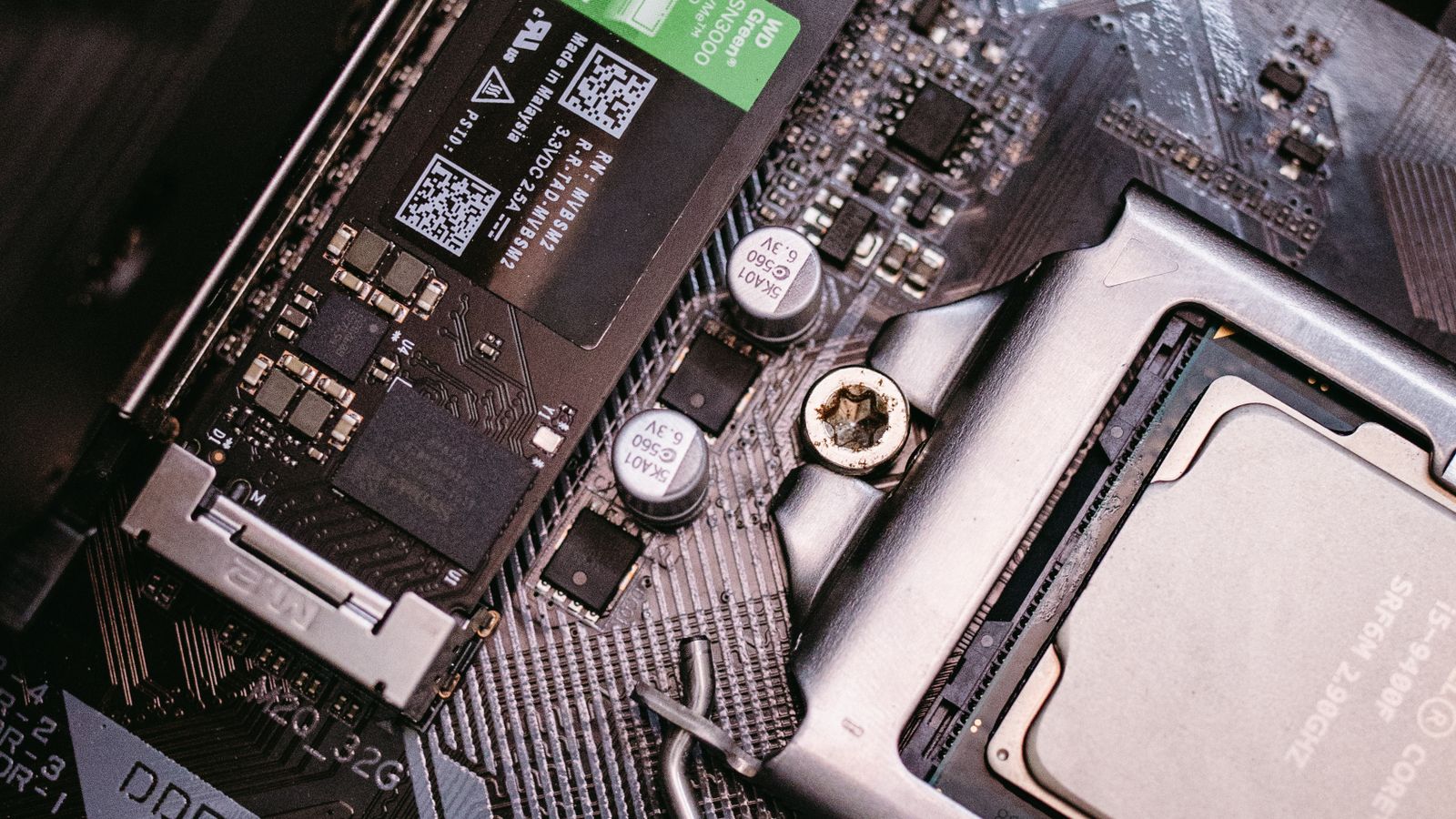The Stutter That Isn't Your GPU: How Game Downloads Throttle Your SSD | Hardvance A WD Green NVMe SSD seated in a motherboard M.2 slot next to the CPU socket