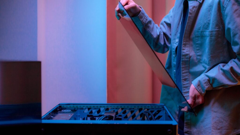 Person removing the glass side panel of a gaming PC case