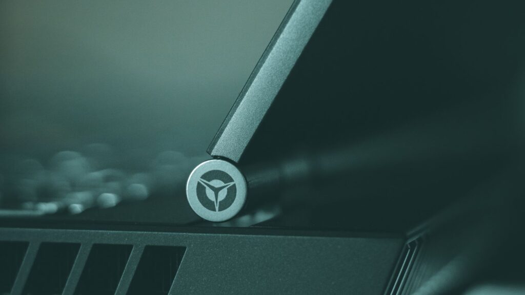 Close-up of a Lenovo Legion laptop hinge, where the display cable runs from the body to the screen