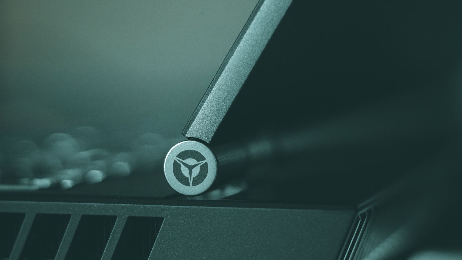 Close-up of a Lenovo Legion laptop hinge, where the display cable runs from the body to the screen