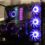 A gaming PC build with RGB cooling fans visible through a tempered glass case
