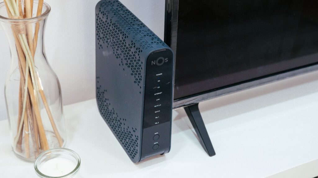 A typical ISP-supplied router and modem next to a television