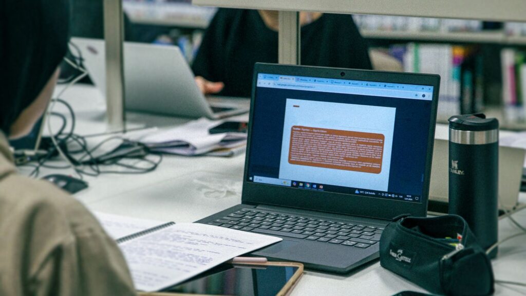 Students working on laptops in a university library
