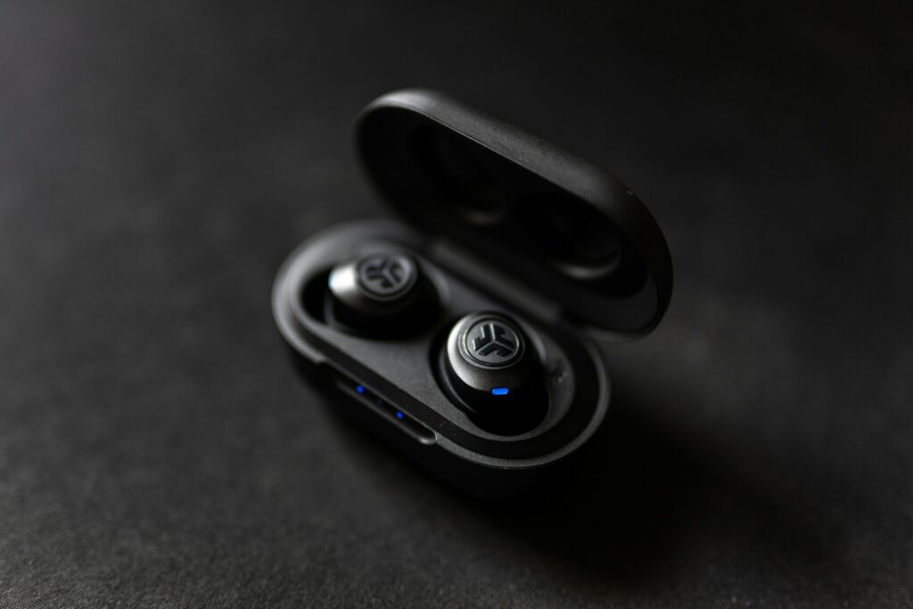 JLab true wireless sport earbuds with ear hooks in their charging case