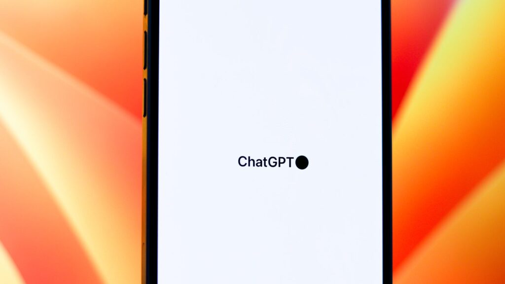 ChatGPT wordmark on a phone screen against an orange background