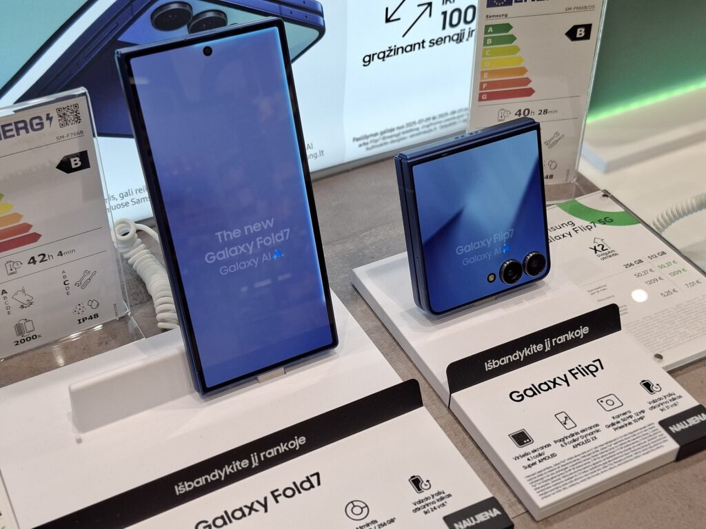 A tall Galaxy Fold next to a small square Galaxy Flip on a retail display