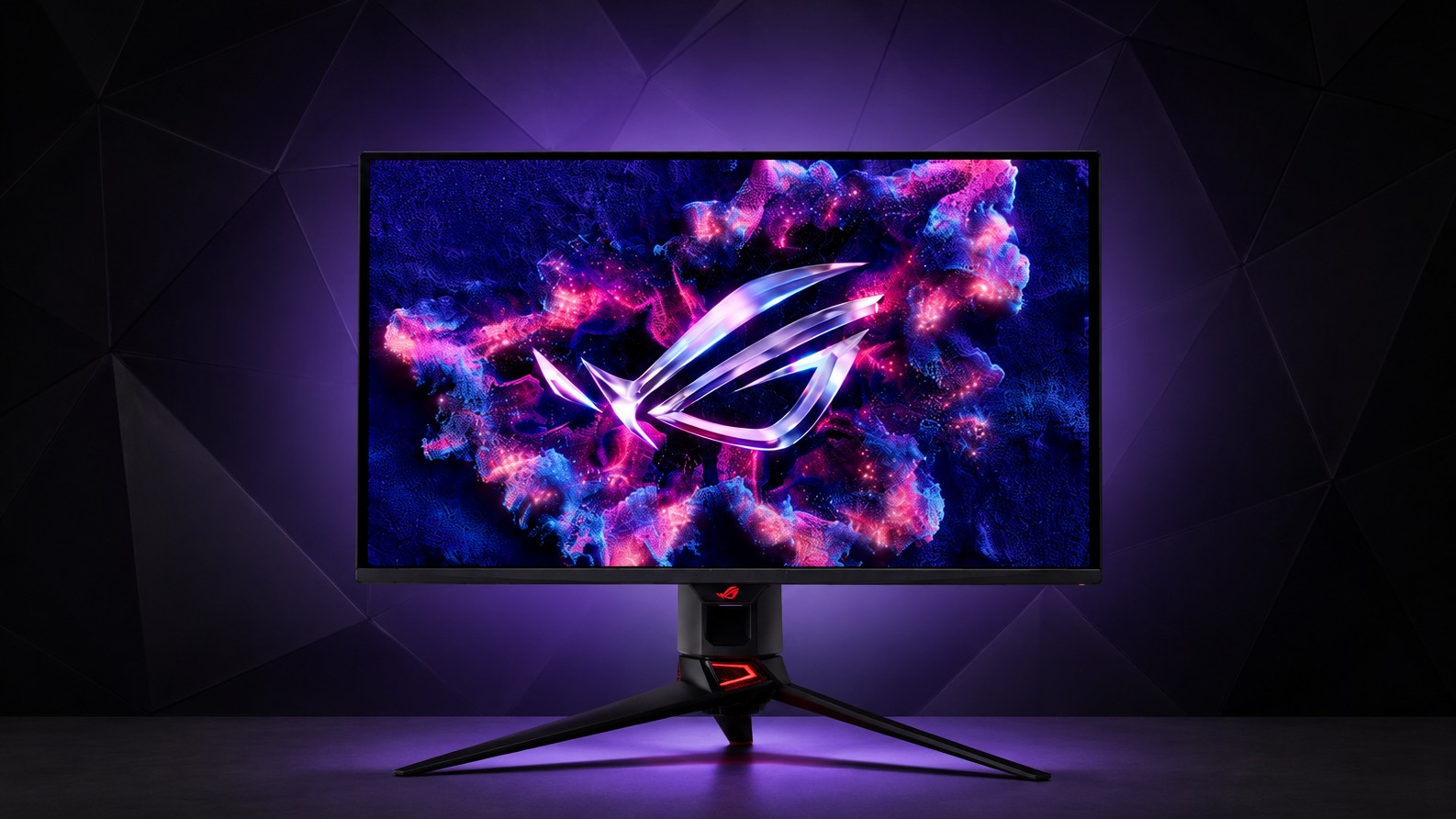 ASUS ROG gaming monitor on a desk lit in purple