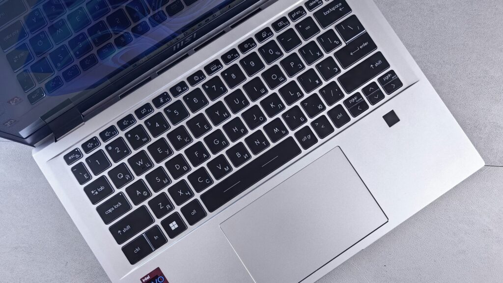 Close-up of a silver laptop keyboard and touchpad