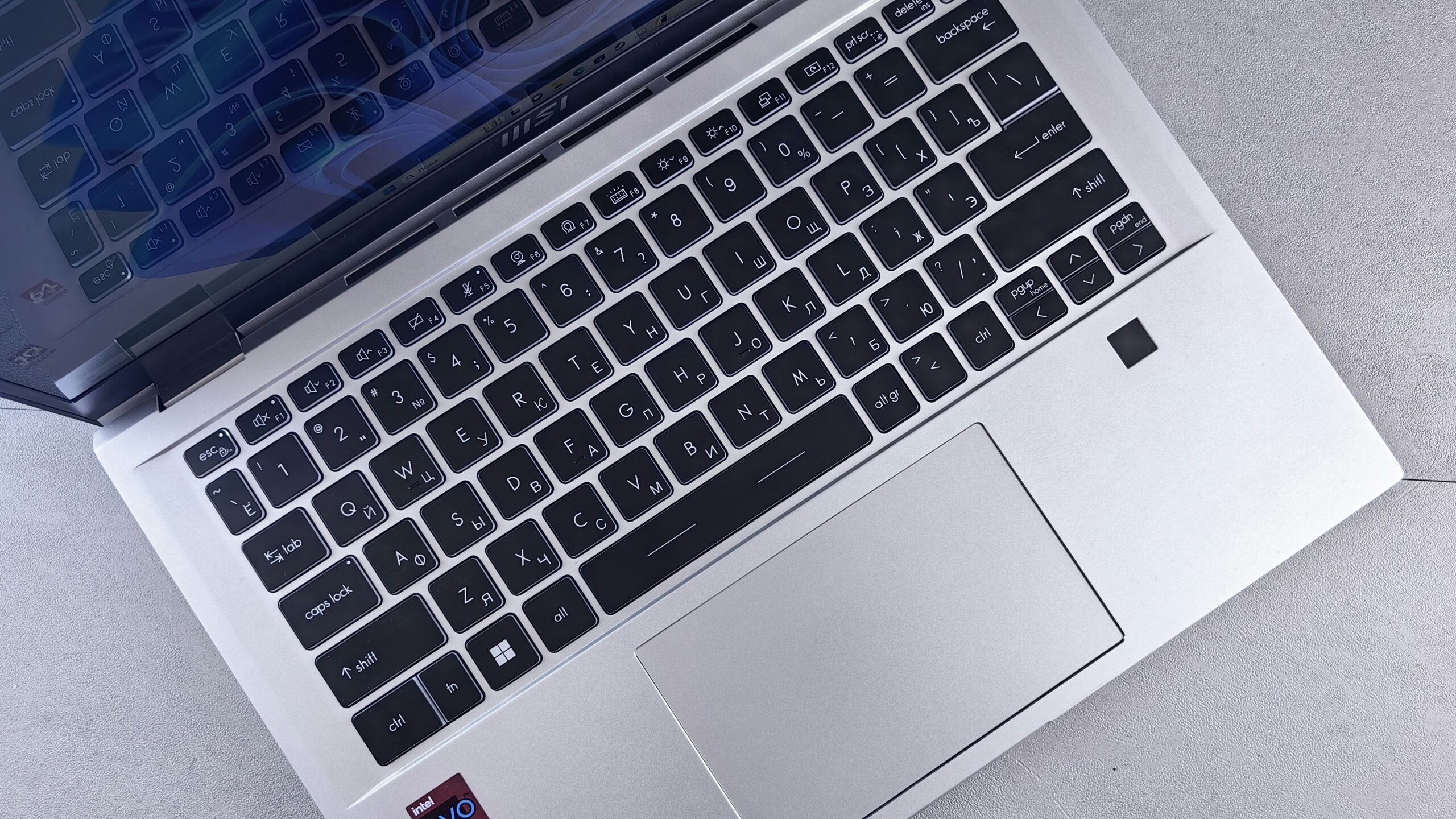 Close-up of a silver laptop keyboard and touchpad