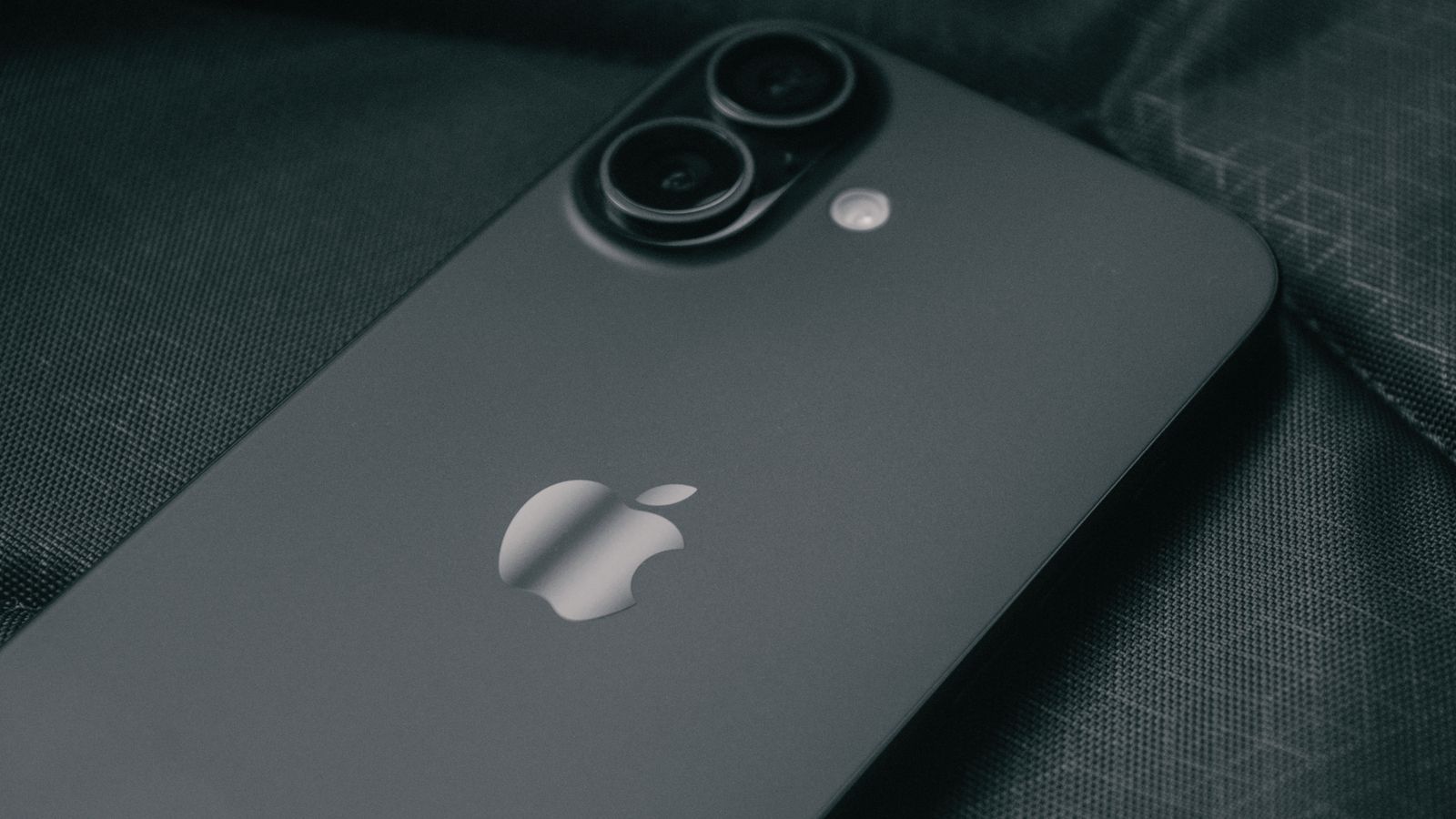 The back of a black standard iPhone showing its dual camera and Apple logo