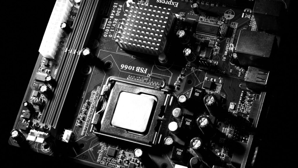 Full computer motherboard from above showing CPU socket, RAM slots and power connectors