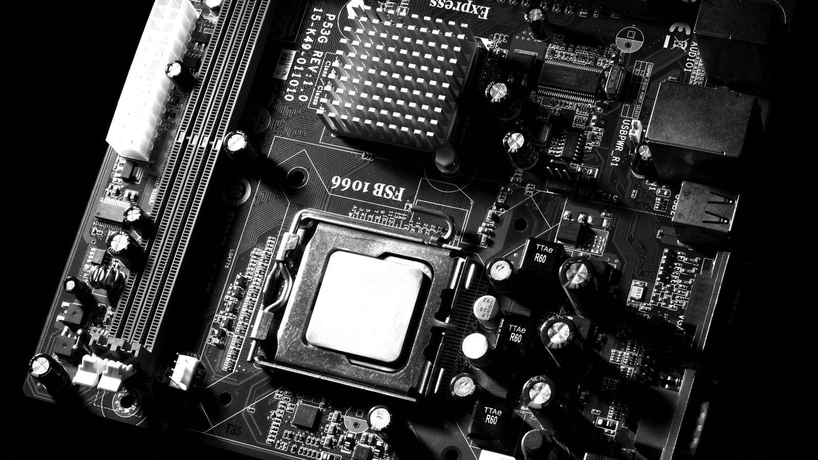 Full computer motherboard from above showing CPU socket, RAM slots and power connectors