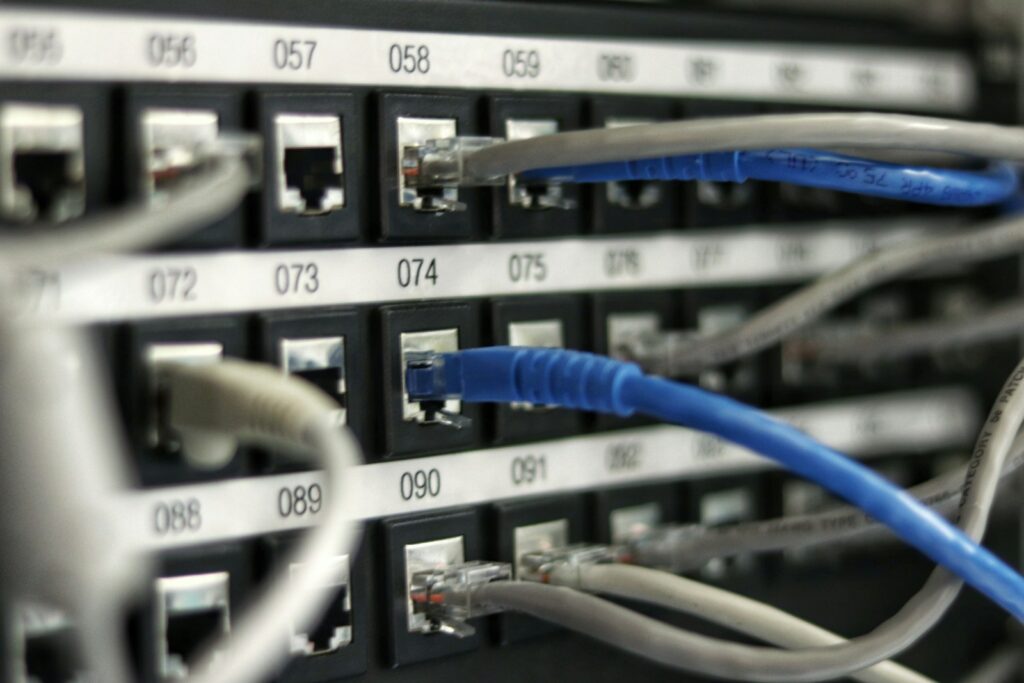 Numbered ports on a network patch panel with cables plugged in