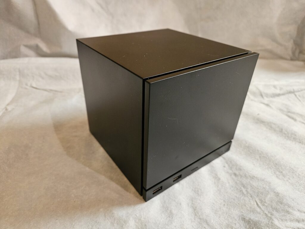 The Valve Steam Machine seen from the front, a compact matte black cube about five litres in volume