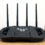 ASUS TUF Gaming WiFi 7 router with six antennas on a wooden desk