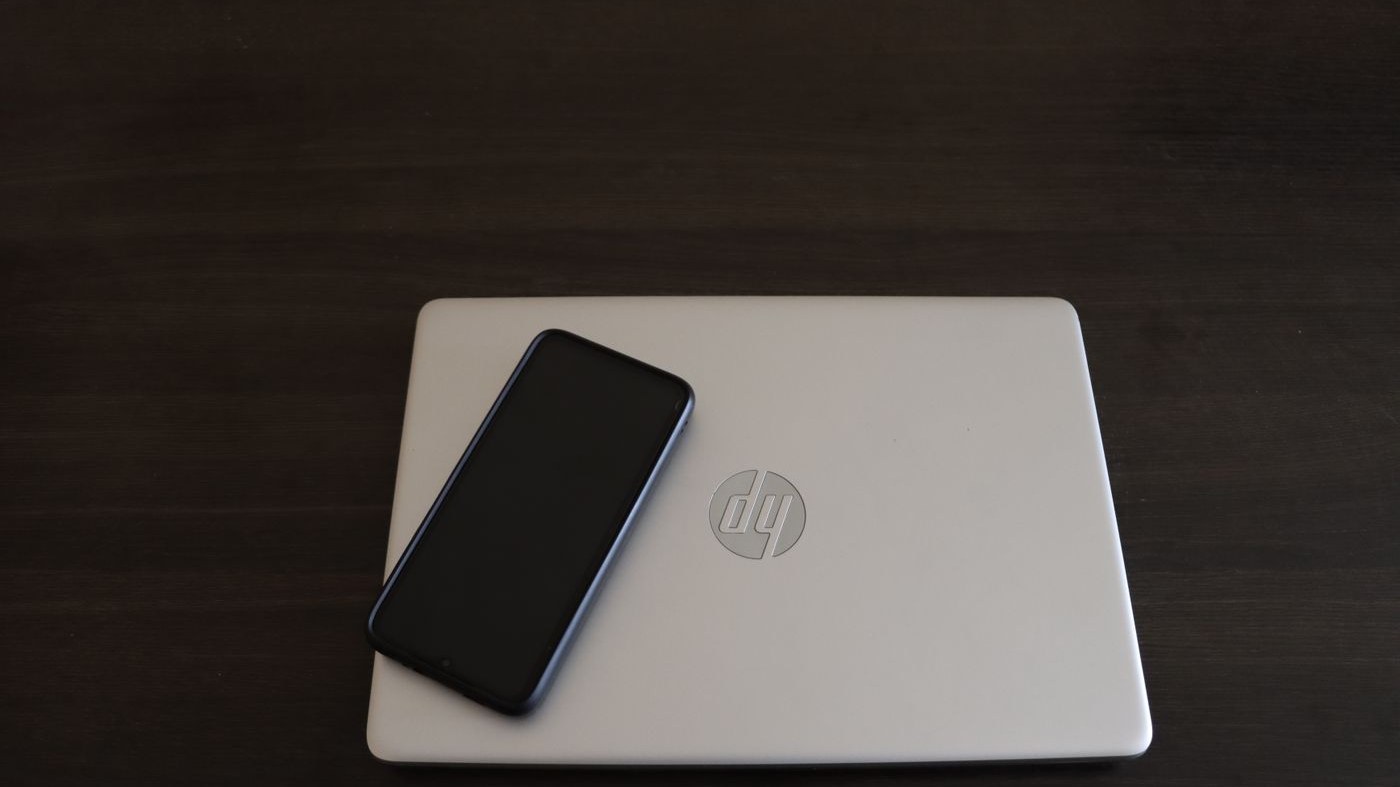 A closed HP laptop with the HP logo on the lid