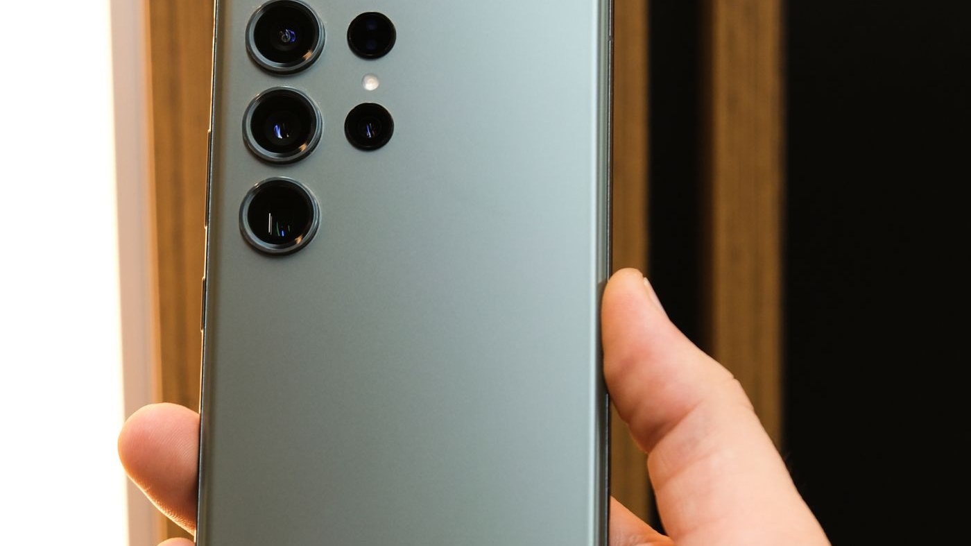 A Samsung Galaxy held in one hand with the side key visible on the edge