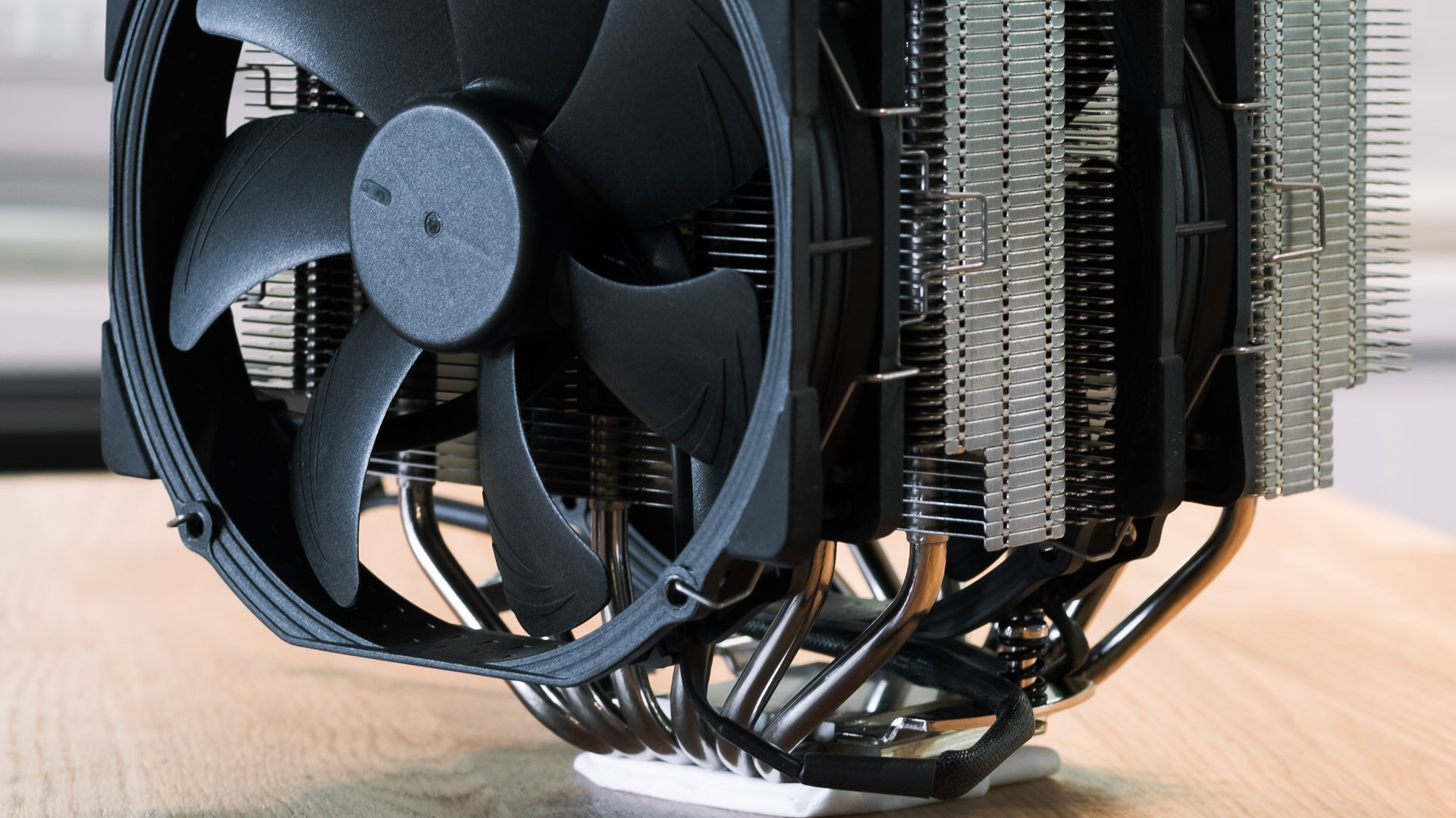 Noctua NH-D15 twin-tower CPU air cooler with black fans on a wooden table