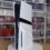 PS5 Pro console standing upright on a turntable in front of shelves of video games