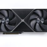 NVIDIA GeForce RTX 5080 Founders Edition graphics card with two fans, lying on a white surface