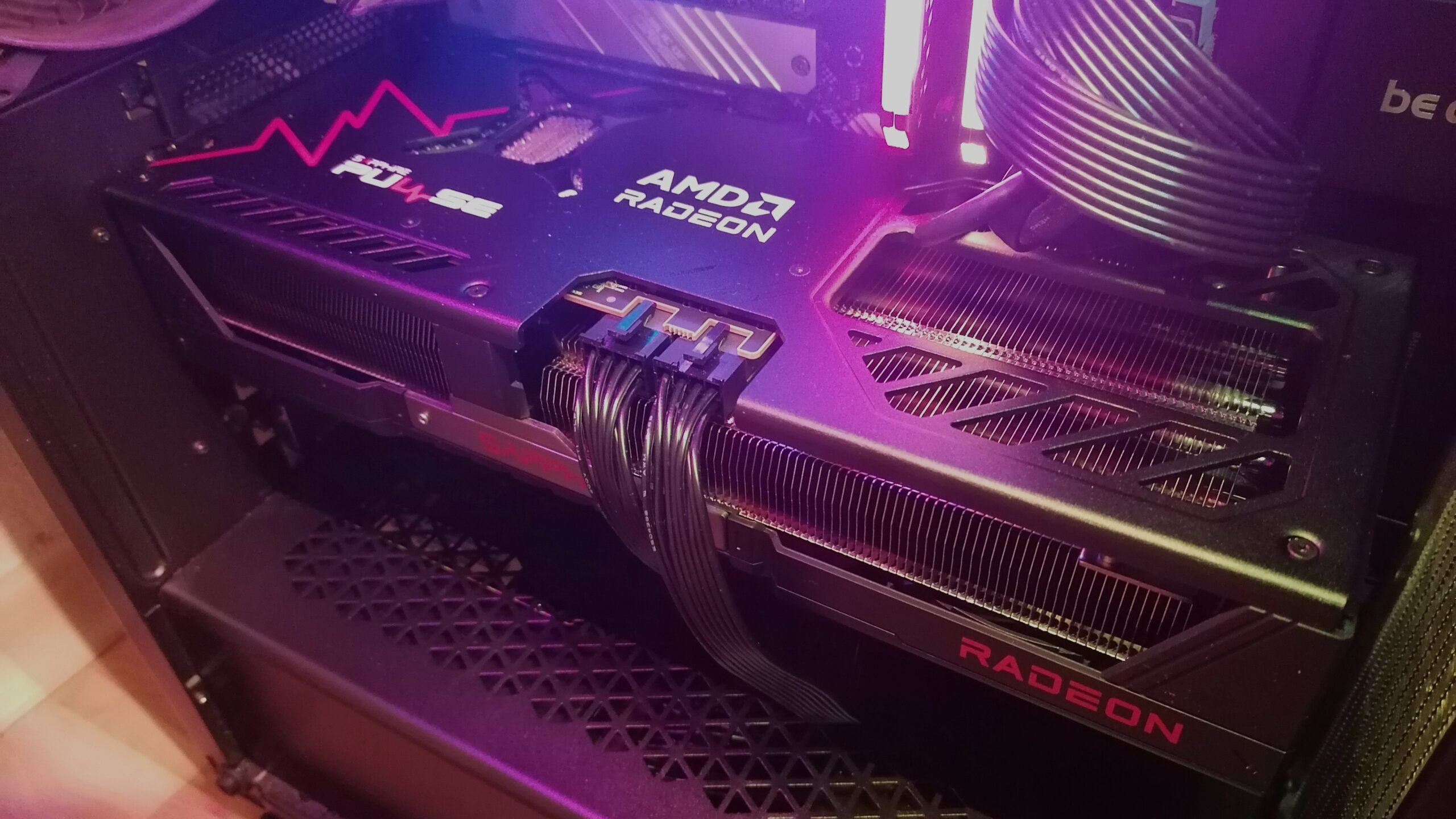 A Sapphire Pulse Radeon RX 9070 XT graphics card installed in a PC with two power cables connected