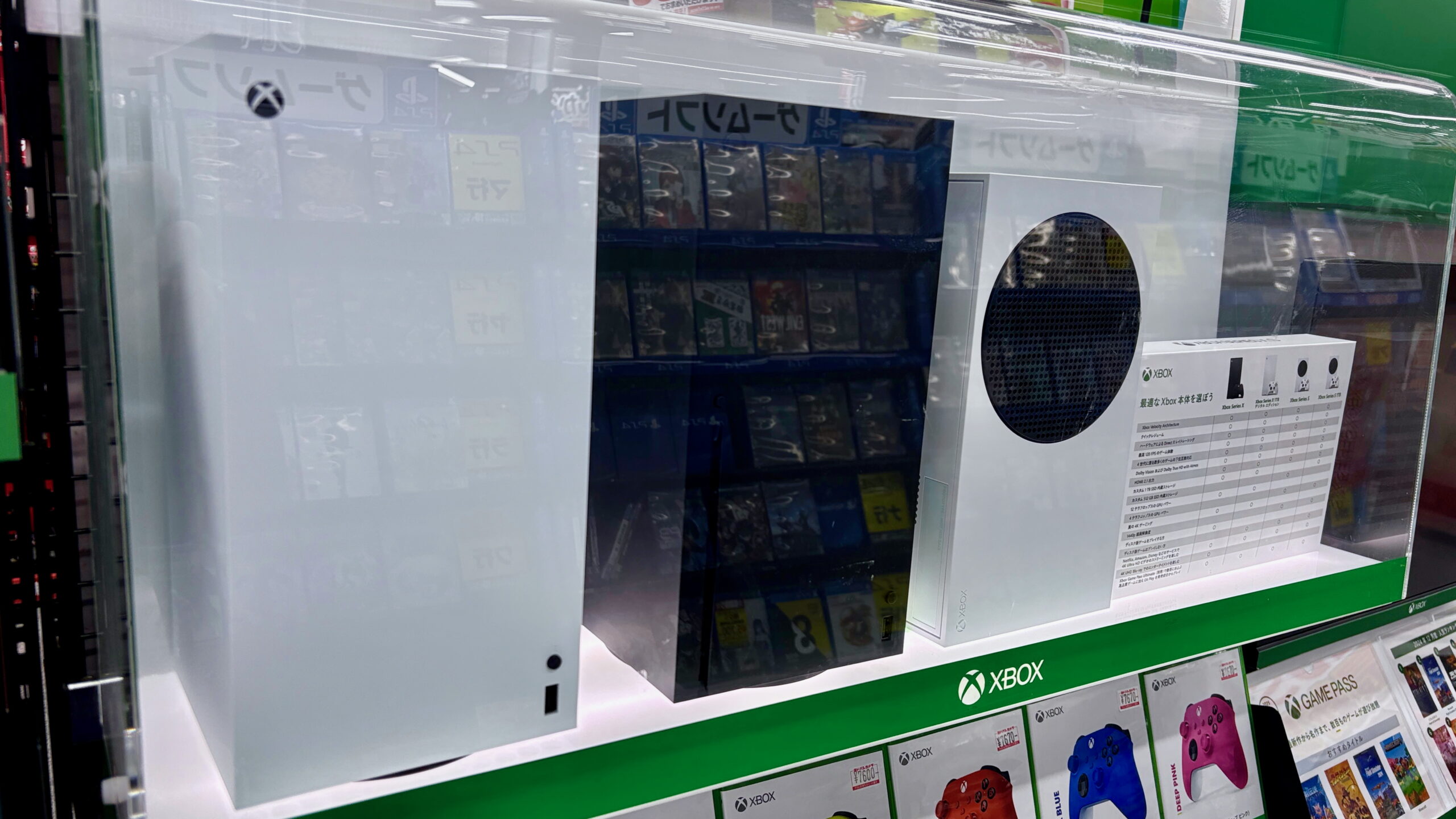 Xbox Series X and Xbox Series S consoles on a shop display shelf